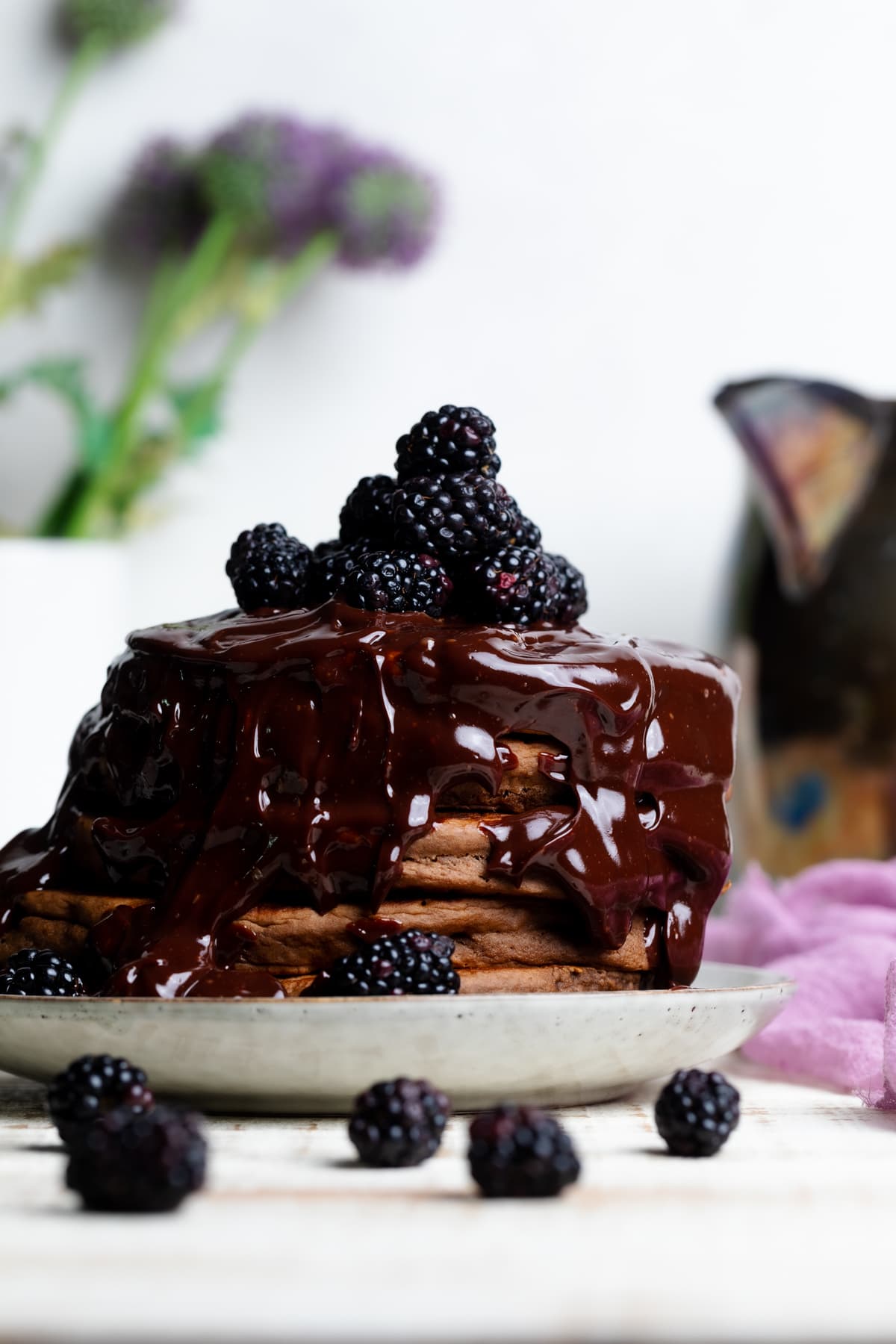 Chocolate drizzled over Vegan Chocolate Pancakes with Blackberries.