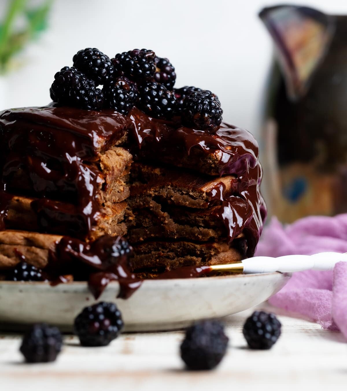 Stack of Vegan Chocolate Pancakes  topped with Blackberries.