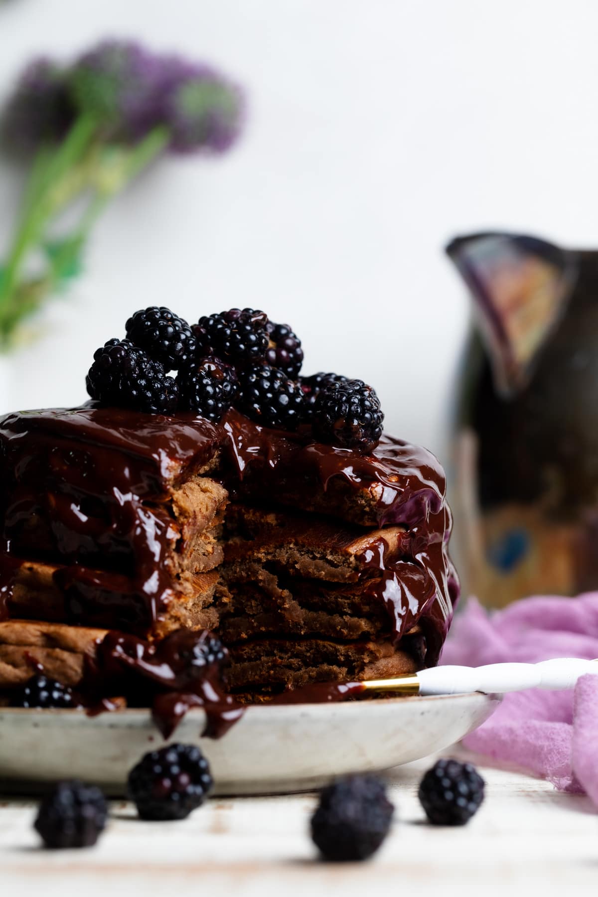 Stack of Vegan Chocolate Pancakes  topped with Blackberries.