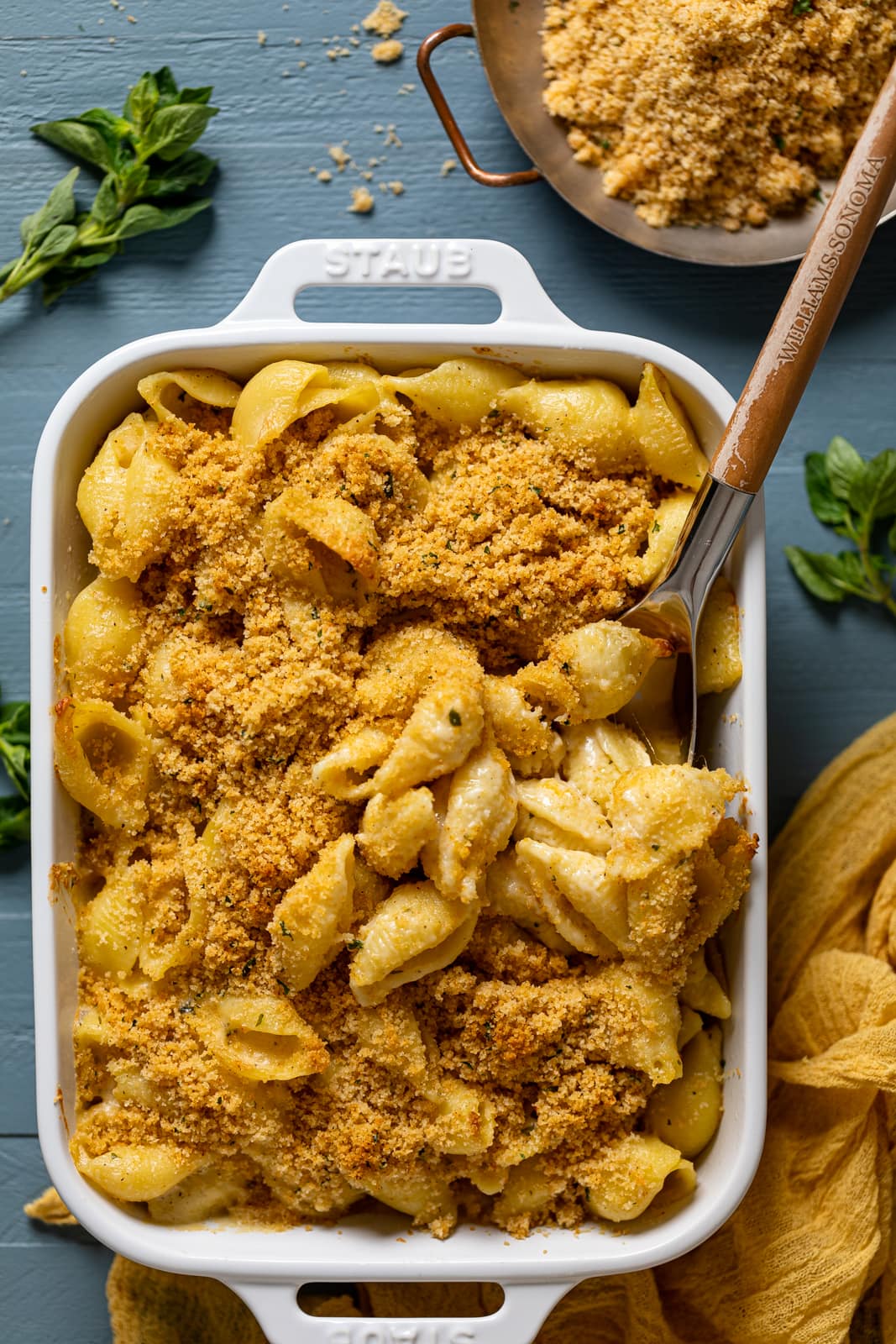 Spoon scooping some Southern Baked Mac and Cheese with Breadcrumbs out of a baking pan--The ultimate soul food.