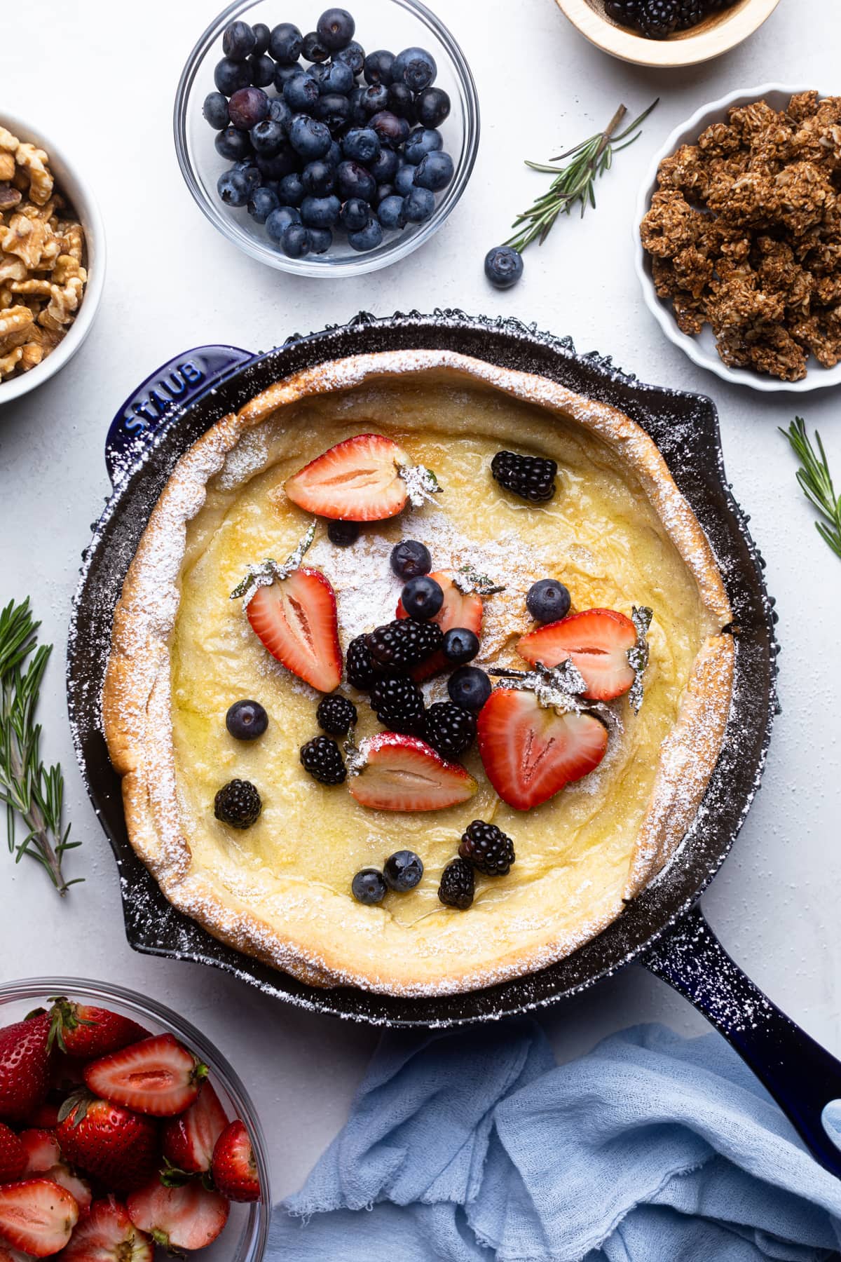 Cast iron skillet with a Dutch Baby Pancake with Berries.