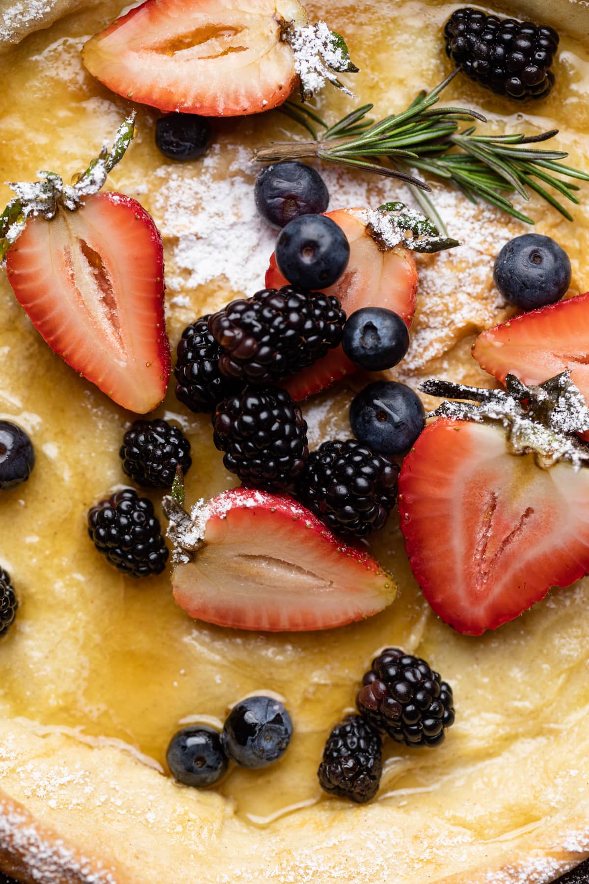 Strawberries, blueberries, and blackberries on a Dutch Baby Pancake.