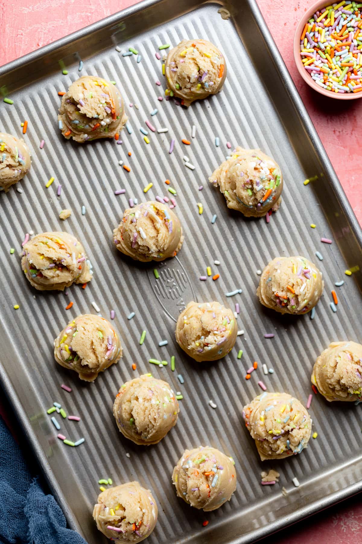 Edible Vegan Funfetti Cookie Dough scooped onto a baking sheet.