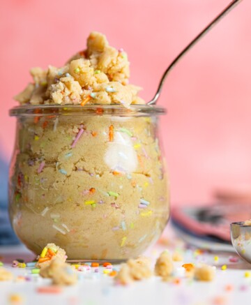 Spoon in a glass of Edible Vegan Funfetti Cookie Dough.