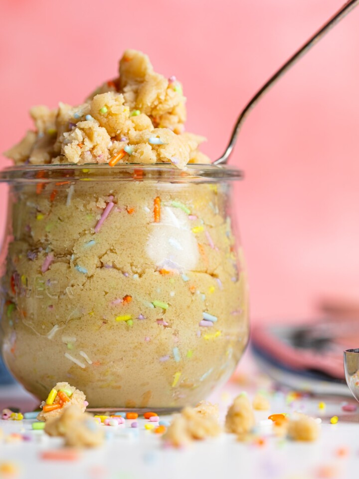 Spoon in a glass of Edible Vegan Funfetti Cookie Dough.