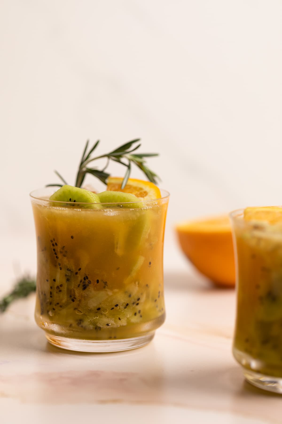 Two glasses of Orange Kiwi Ginger Mocktail.