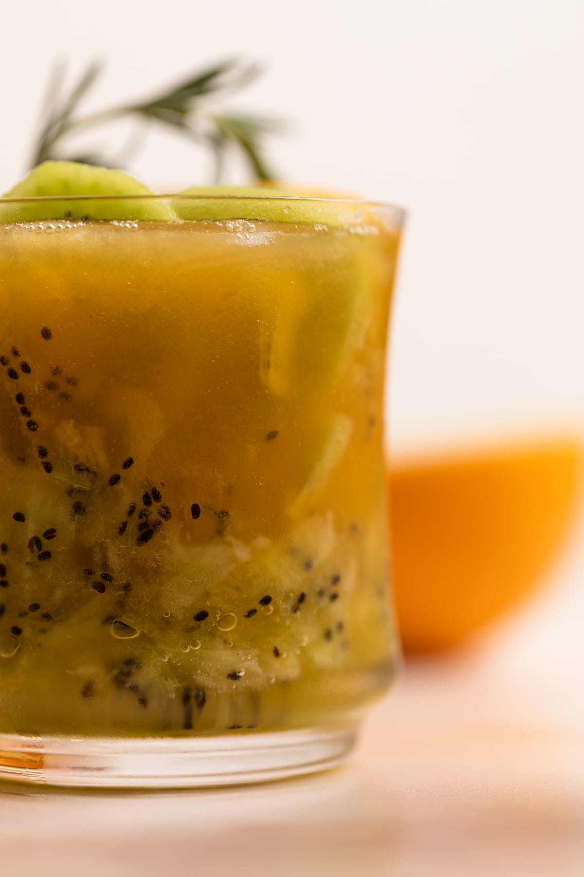 Closeup of a glass of Orange Kiwi Ginger Mocktail.