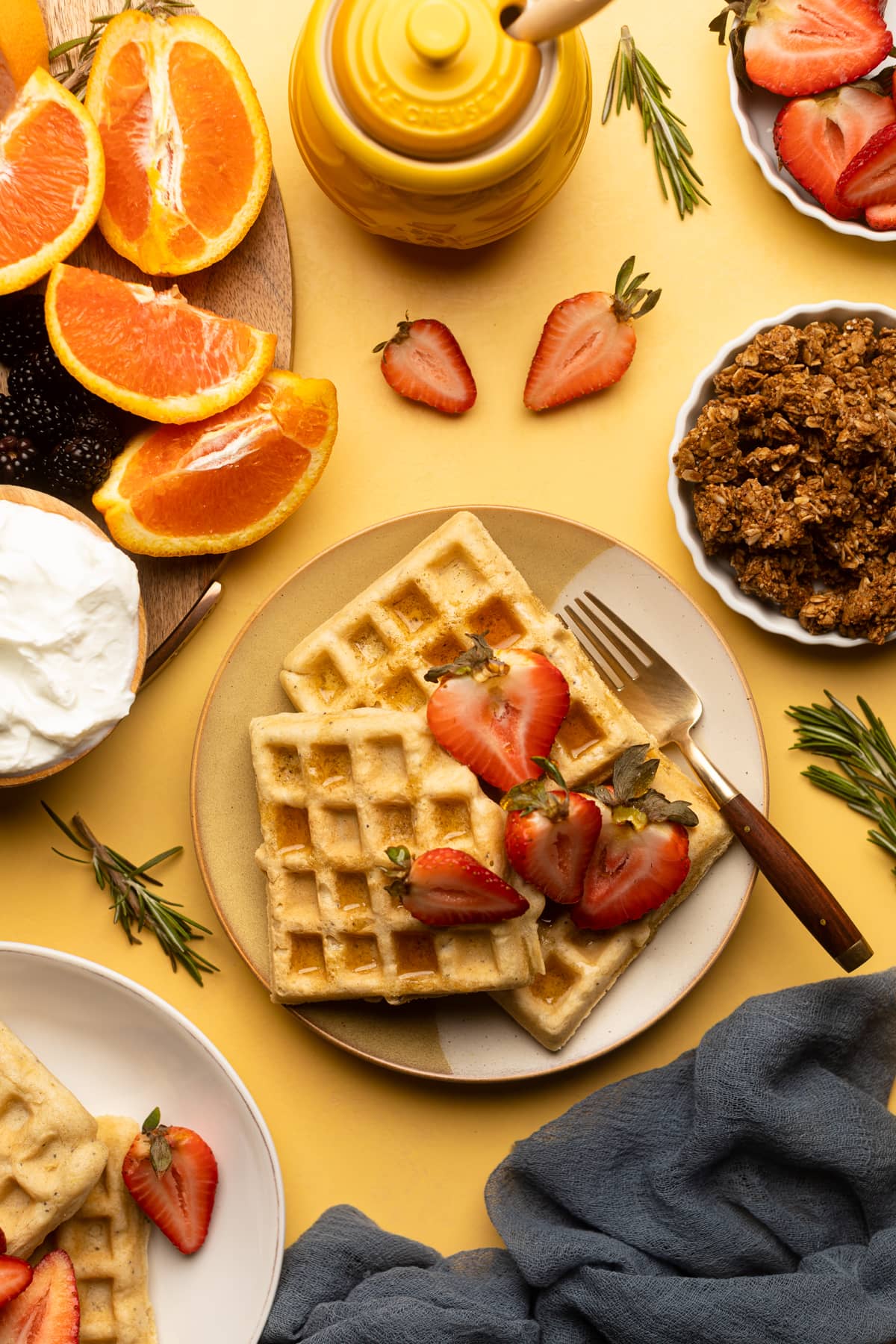 Sliced strawberries atop Gluten-Free Lemon Poppyseed Waffles.