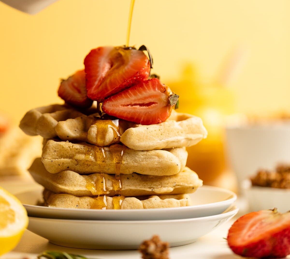 Syrup pouring over Gluten-Free Lemon Poppyseed Waffles.