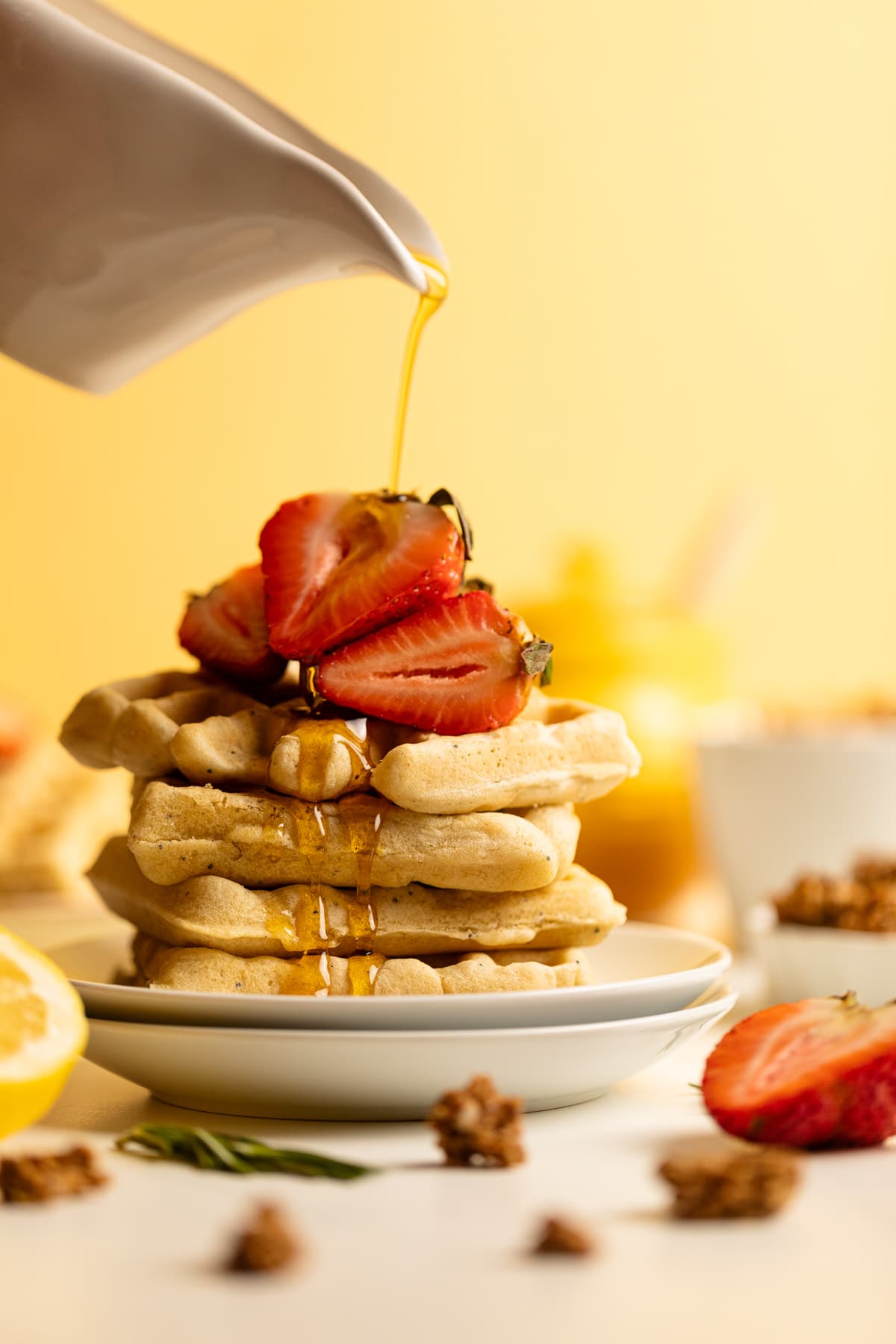 Syrup pouring over Gluten-Free Lemon Poppyseed Waffles.