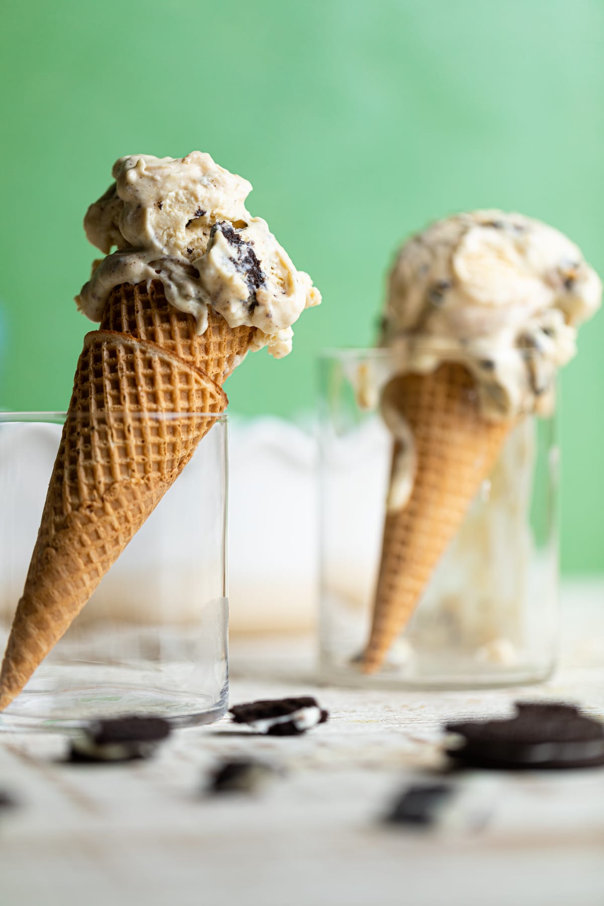 Two cones of No-Churn Peanut Butter Oreo Ice Cream in glasses.