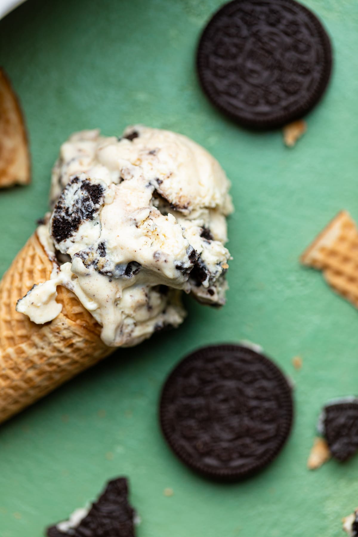 No-Churn Peanut Butter Oreo Ice Cream in a cone with Oreos.