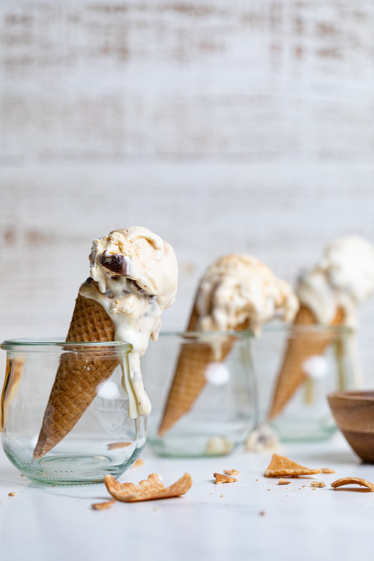 Loaded No-Churn Snickers Ice Cream cones standing in glass jars.