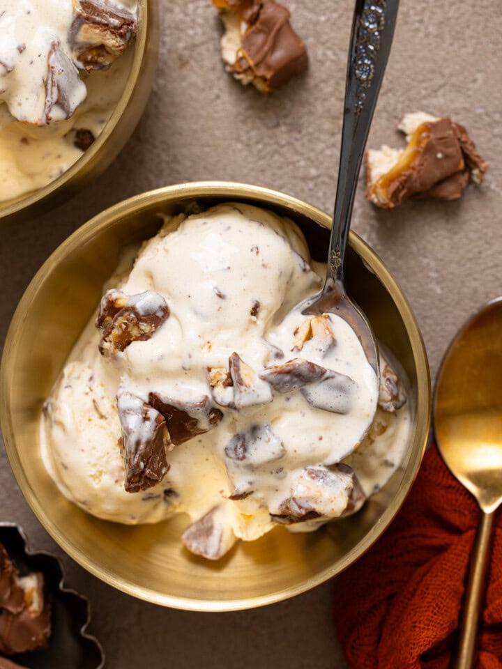 Up close shot of Snickers bar ice cream with spoons.