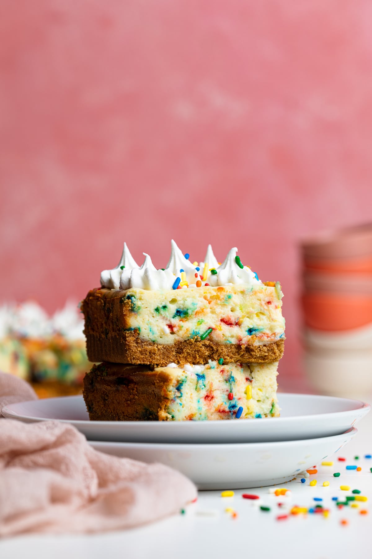 Funfetti Cheesecake Bar on two stacked plates.