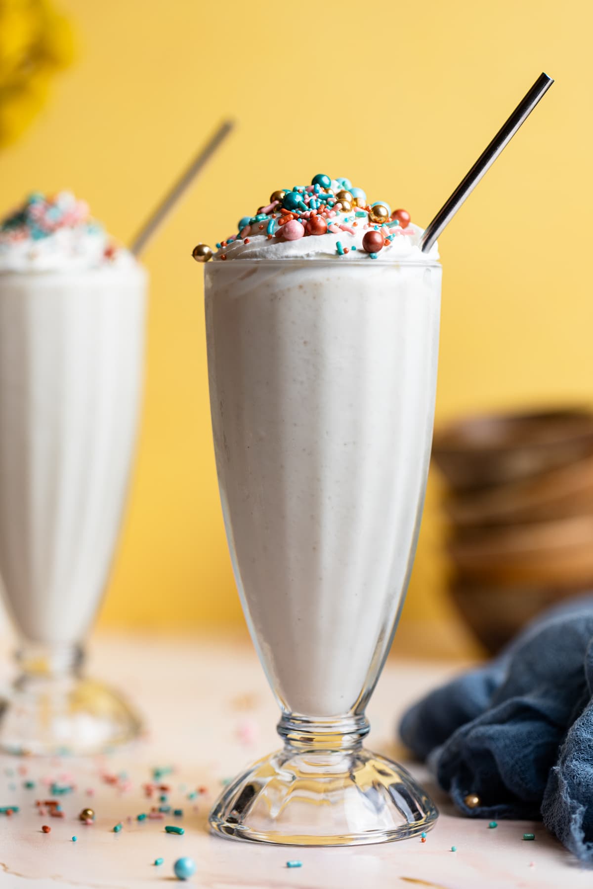 Two Dairy-Free Vanilla Funfetti Milkshakes with straws.