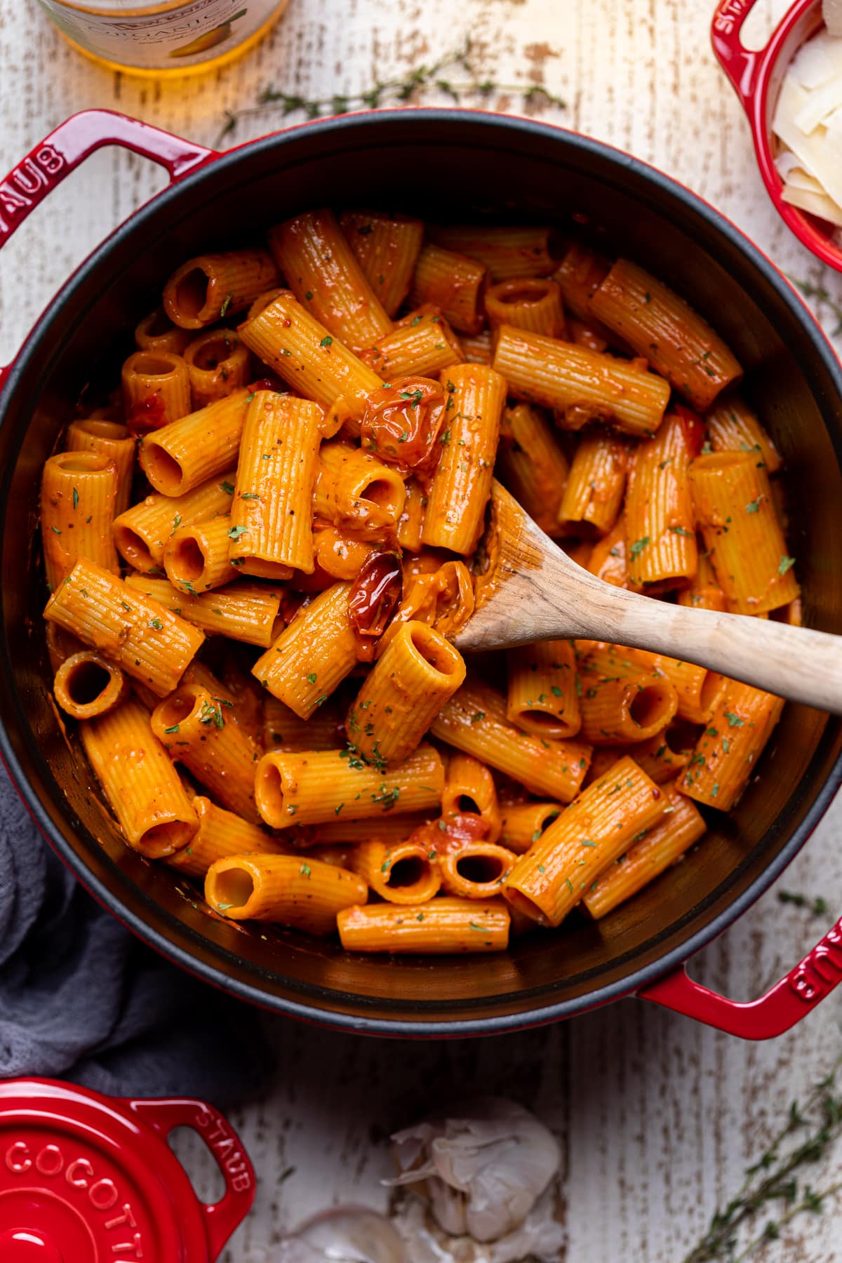 Wooden spoon stirring a pot of Spicy Cajun Vodka Pasta without Vodka