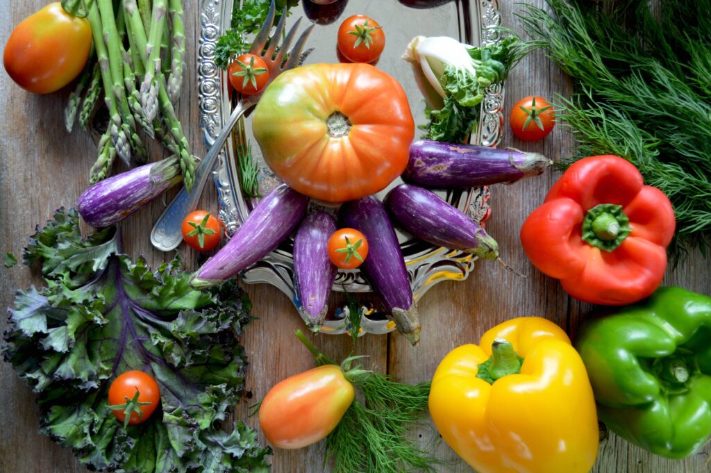 Platter and table filled with colorful vegetables.