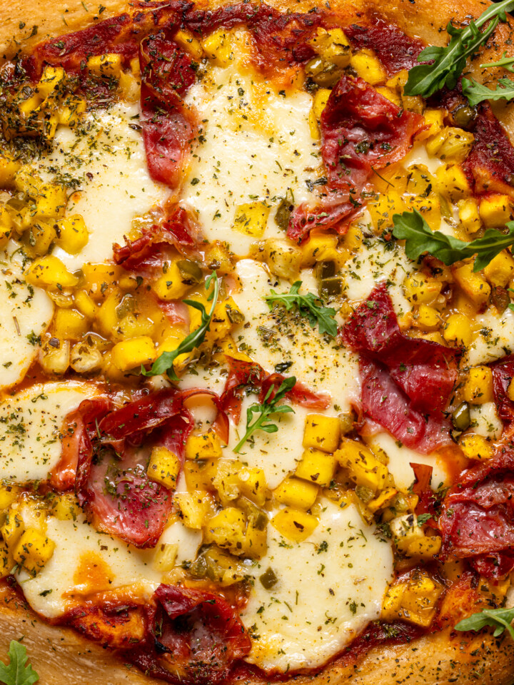 Image of baked Hawaiian pizza with toppings.