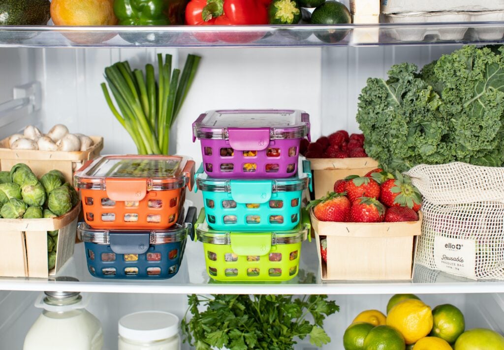 Refrigerator full of colorful containers.