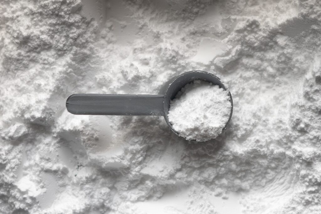 Measuring spoon in a pile of flour.
