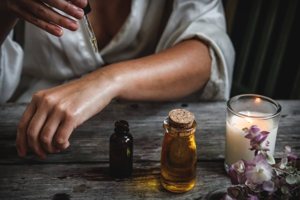 Person dropping oils onto their skin