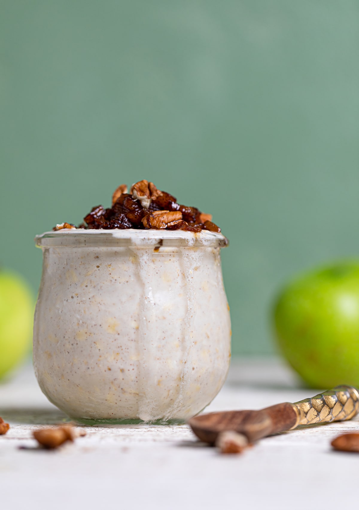 Overflowing glass of Apple Pie Overnight Oats.