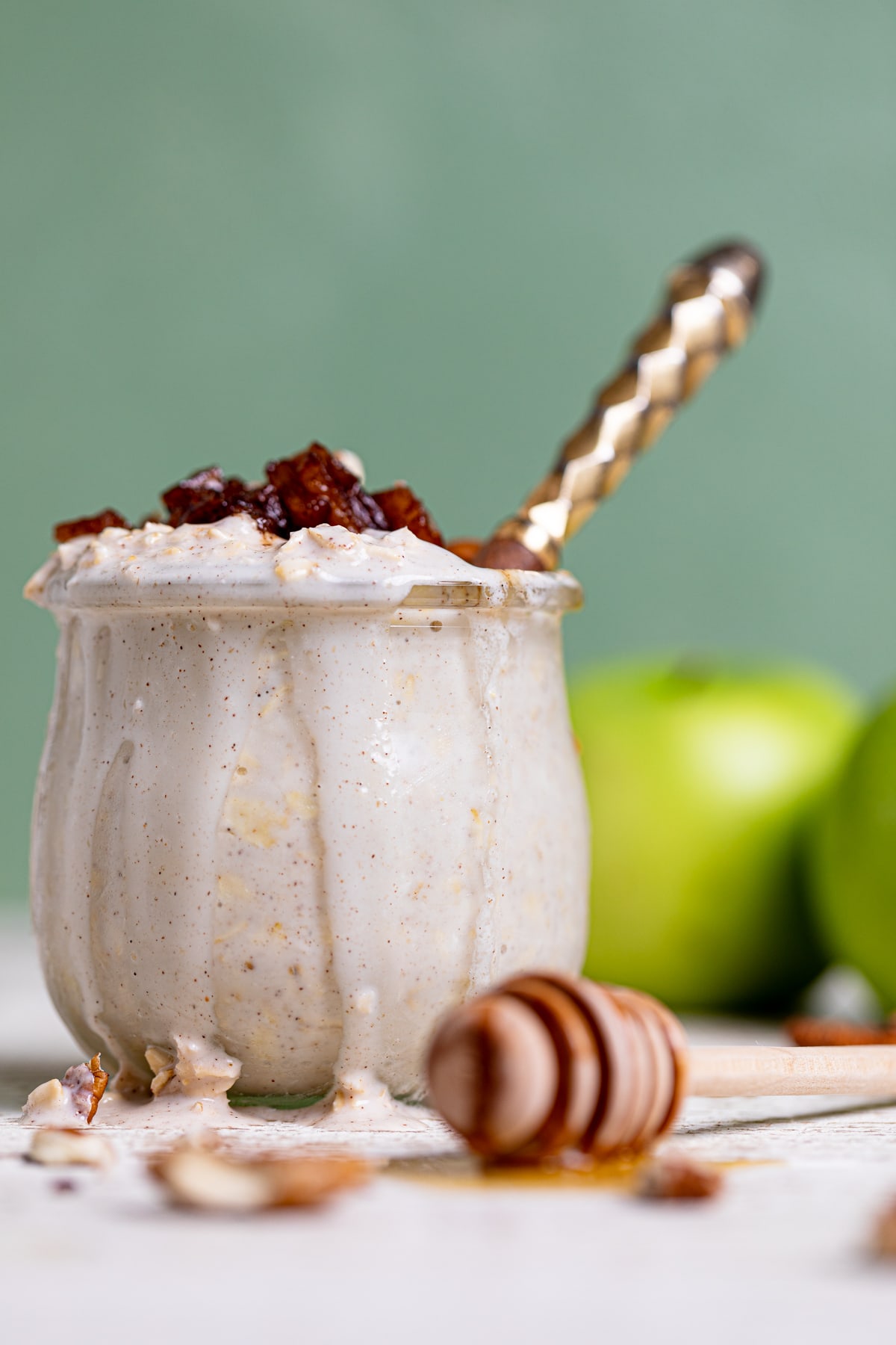 Spoon in a glass of Apple Pie Overnight Oats.