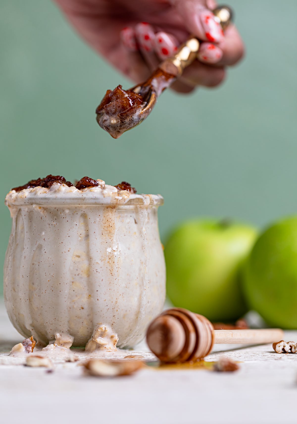 Spoon scooping Apple Pie Overnight Oats from a glass.