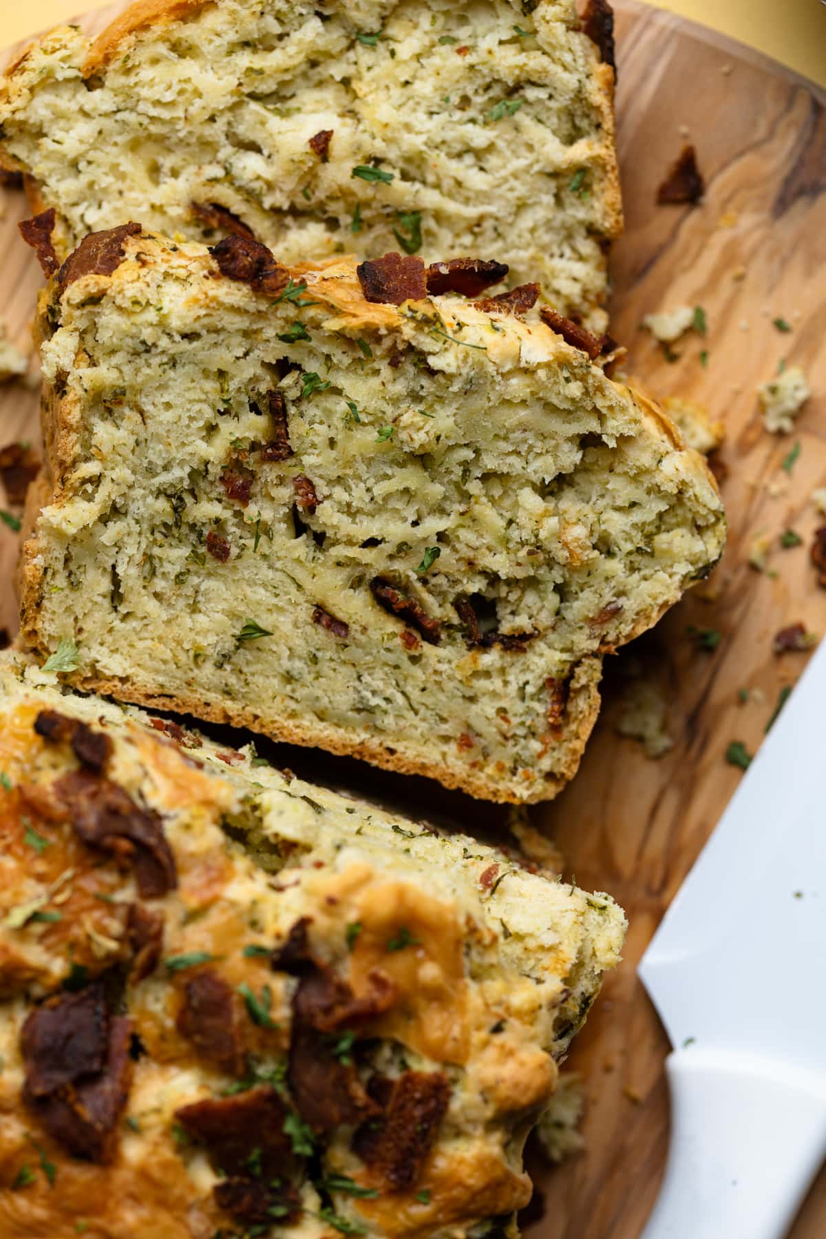 Slice of Loaded Cheddar Pesto Zucchini Bread with Bacon.