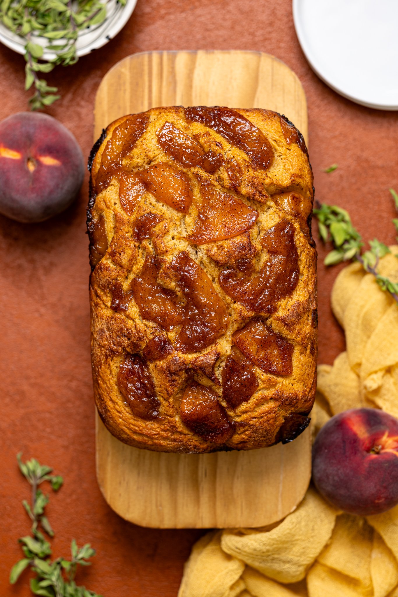 Baked Easy Homemade Cinnamon Peach Bread on a wood platter.