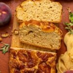 Baked Easy Homemade Cinnamon Peach Bread sliced on a wood platter.