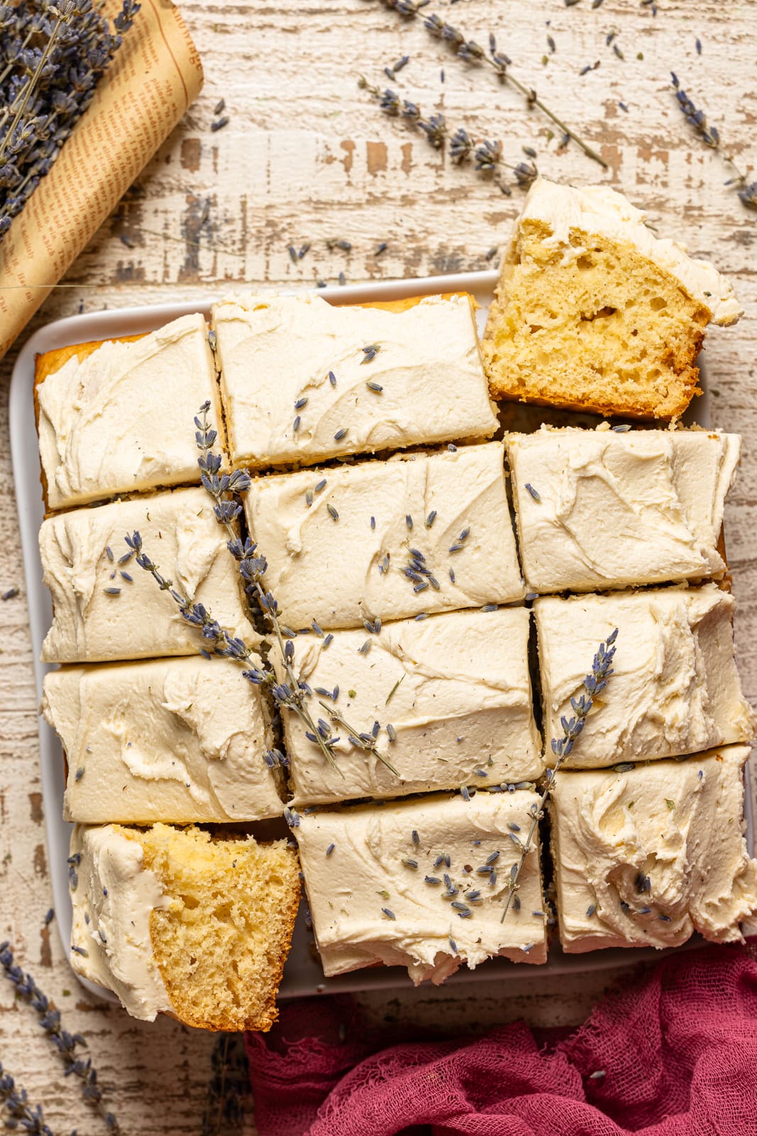 Sheet cake sliced with lavender flowers.