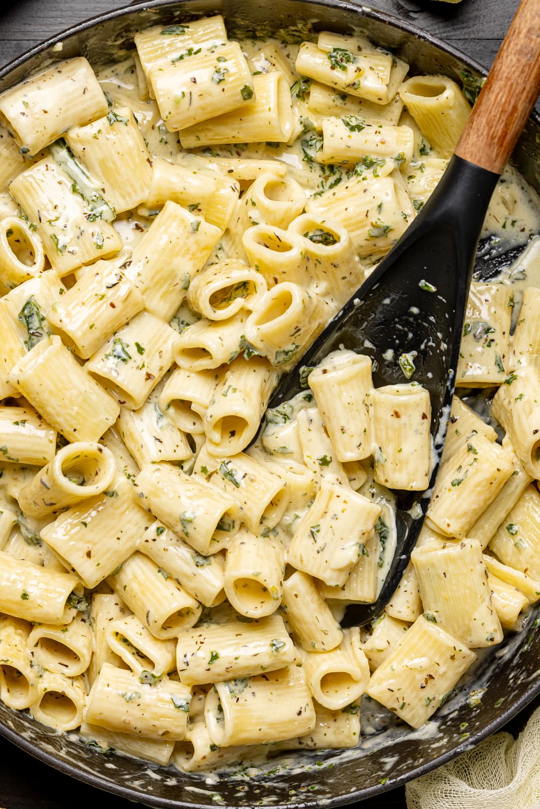 Deep black skillet filled with creamy pasta.