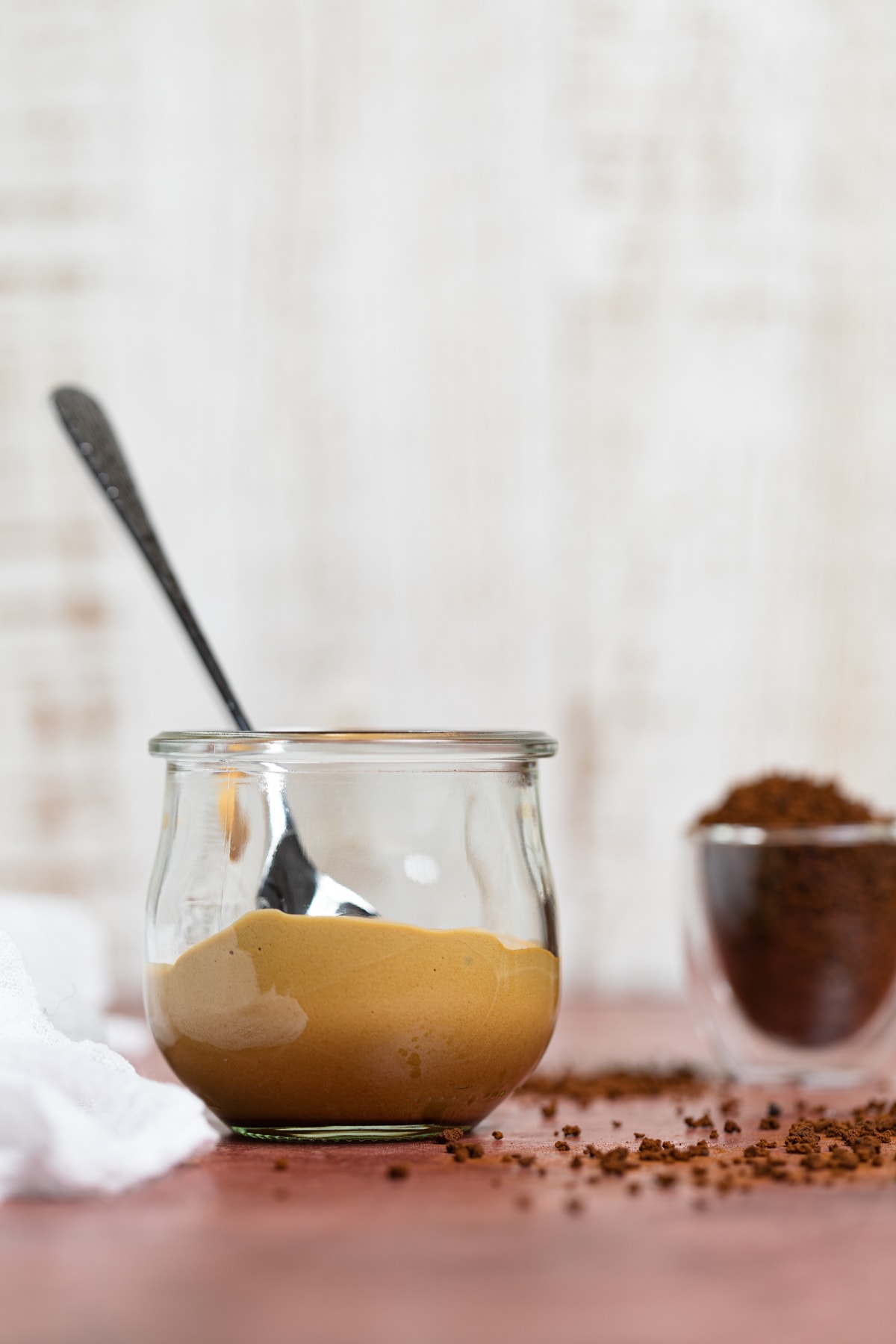 Mostly empty glass of Caramel Mocha Overnight Oats with Whipped Coffee.