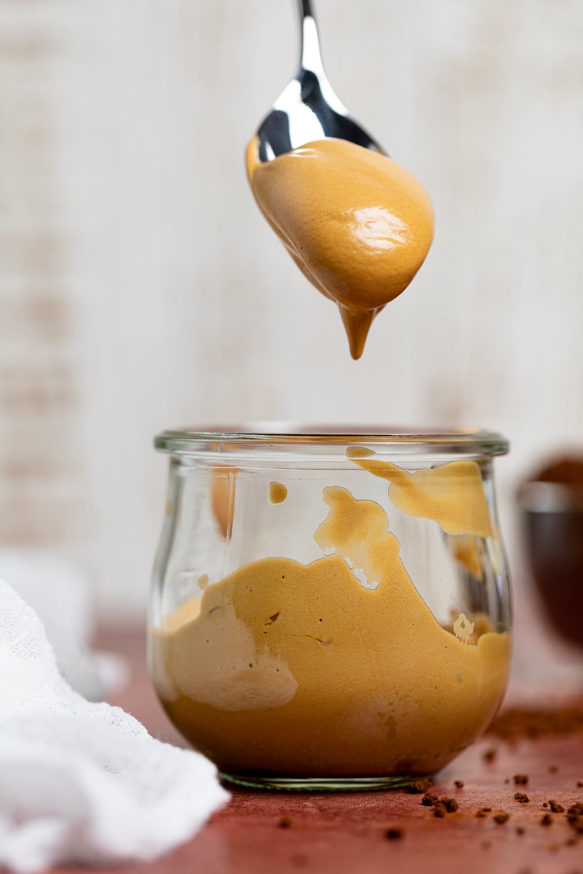 Spoon scooping Caramel Mocha Overnight Oats with Whipped Coffee.