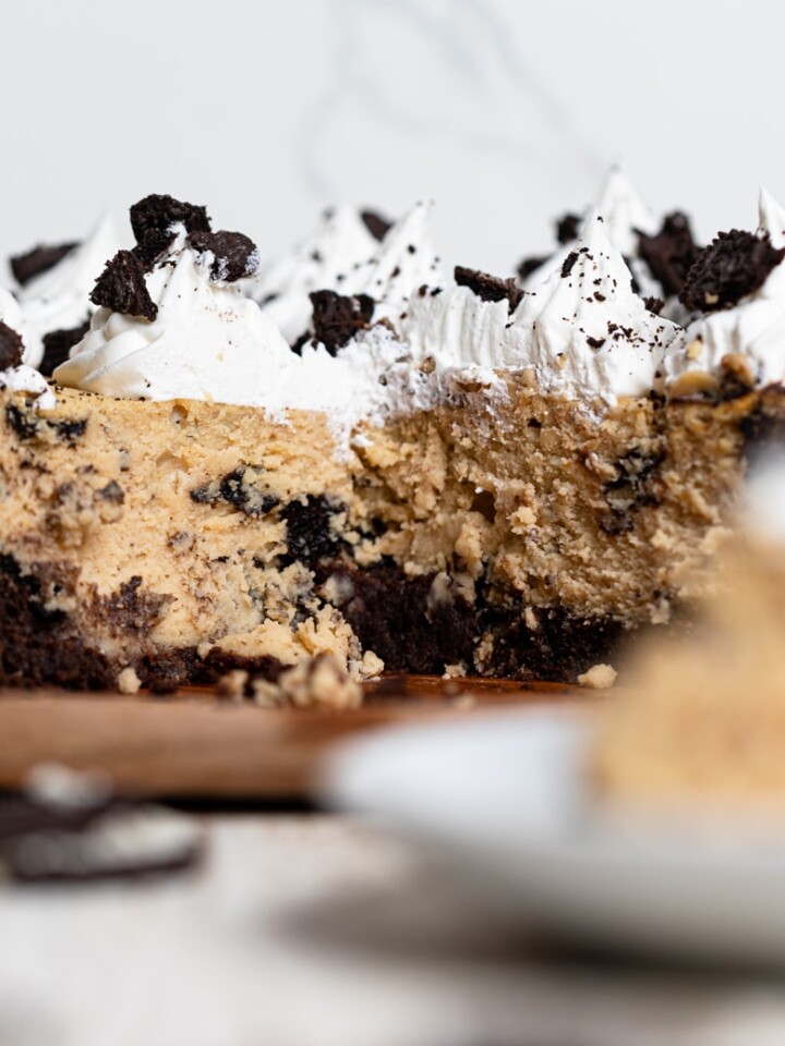 Gluten-Free Peanut Butter Cookies N' Cream Brownie Cheesecake missing a slice