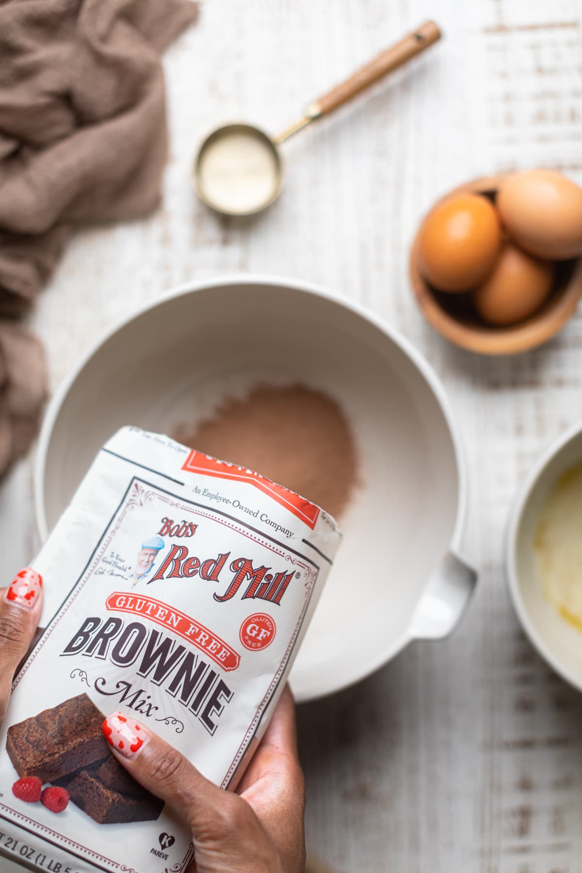 Bob\'s Red Mill gluten-free brownie mix being poured into a bowl