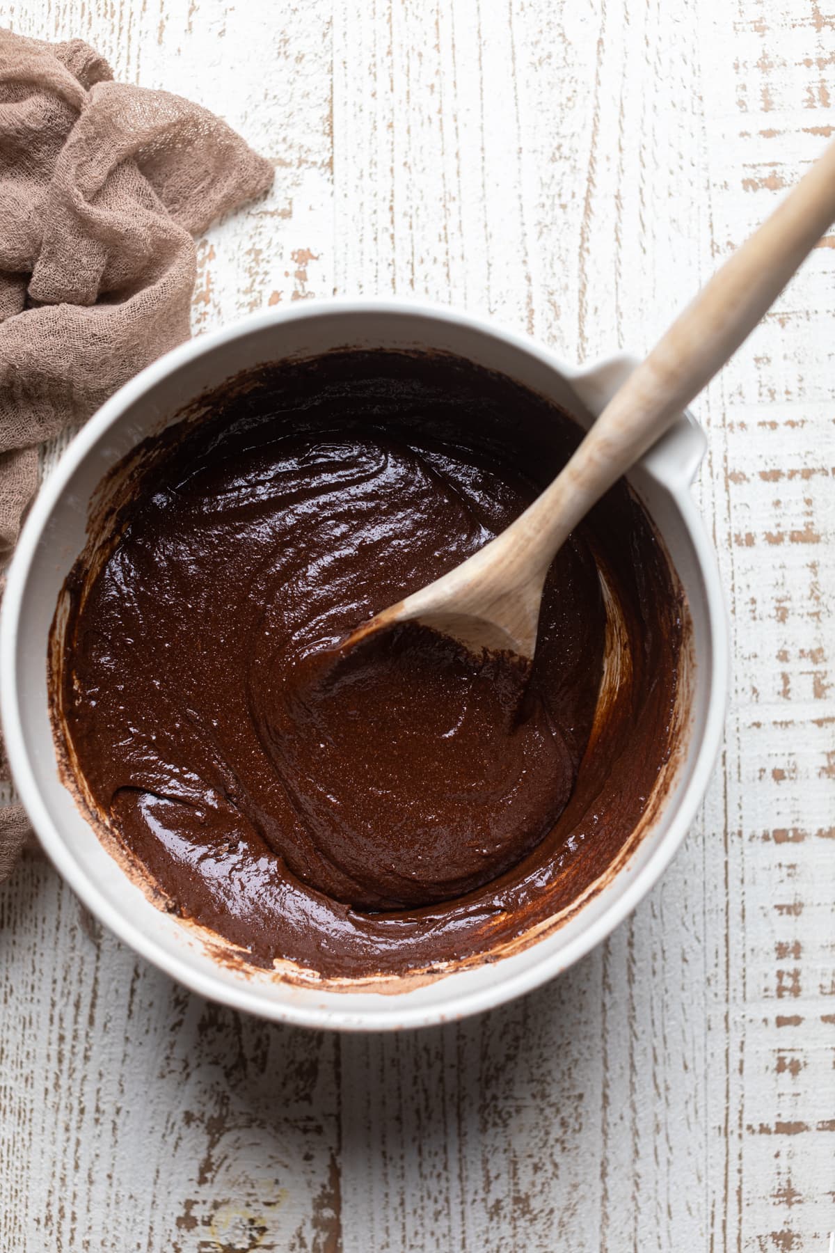 Gluten free brownie crust batter mixed in a bowl with a spoon