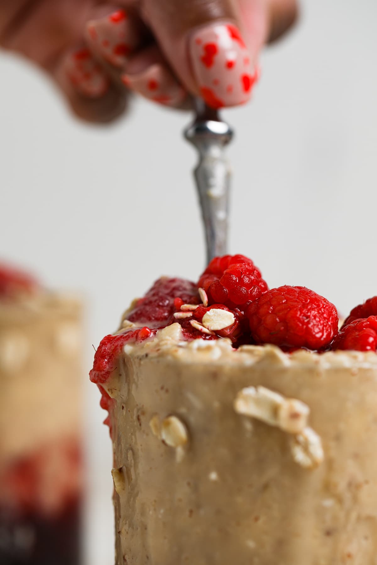 Protein Peanut Butter and Jelly Overnight Oats topped with raspberries.