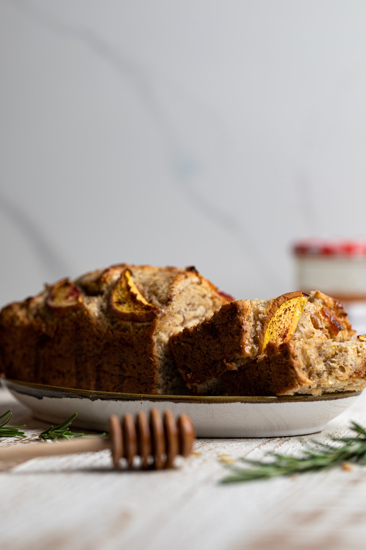 Side view of a partially sliced loaf of Cinnamon Maple Peach Bread 