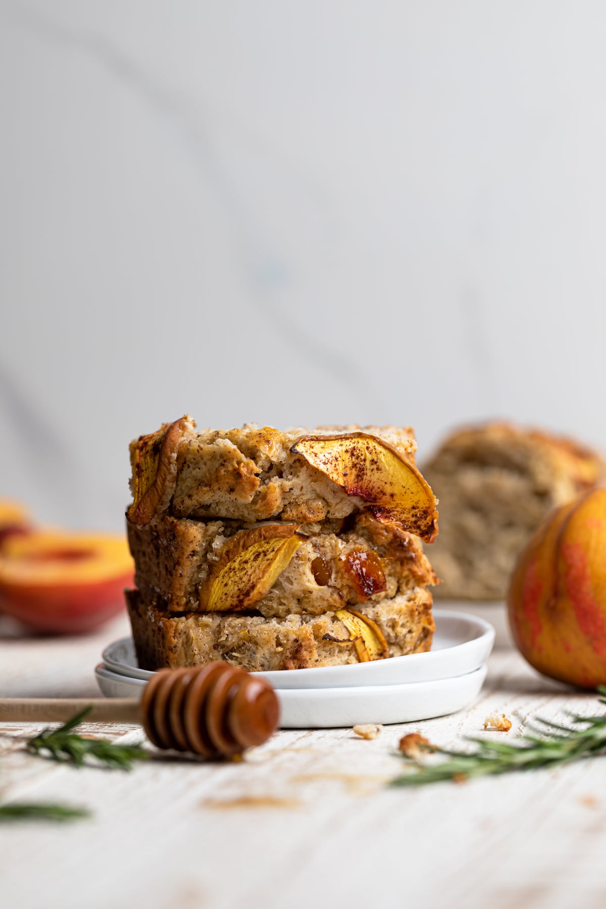 Slices of Cinnamon Maple Peach Bread stacked on small plates