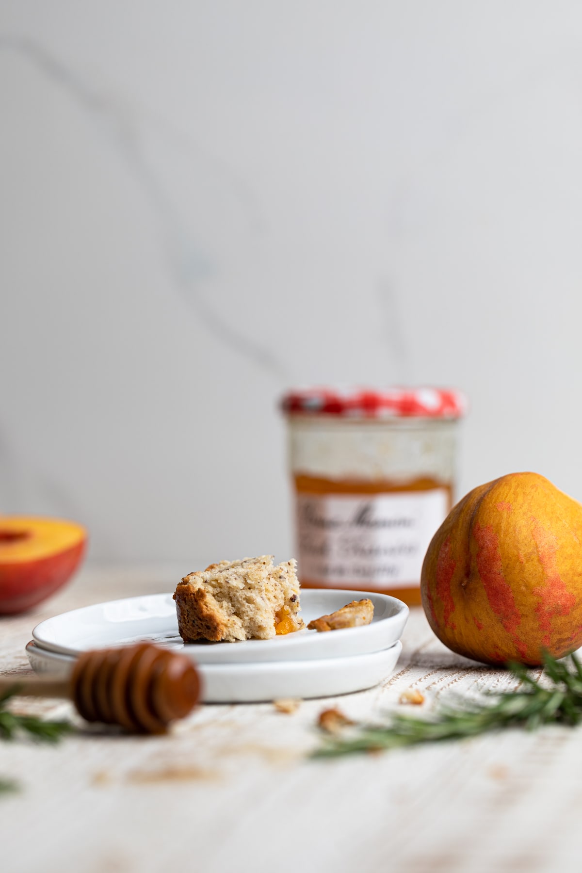 Two small, stacked plated with a bite left of Cinnamon Maple Peach Bread 