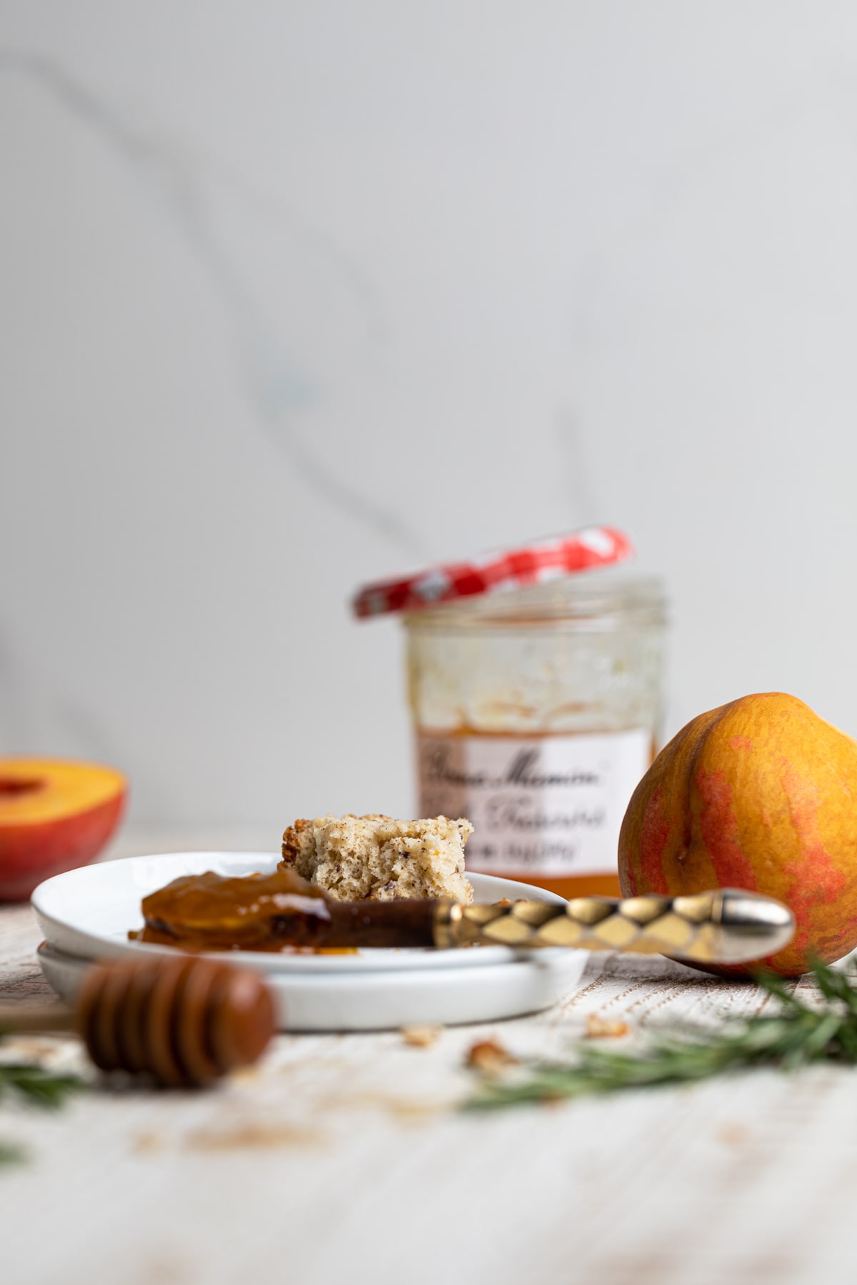 Two small, stacked plated with a bite left of Cinnamon Maple Peach Bread 