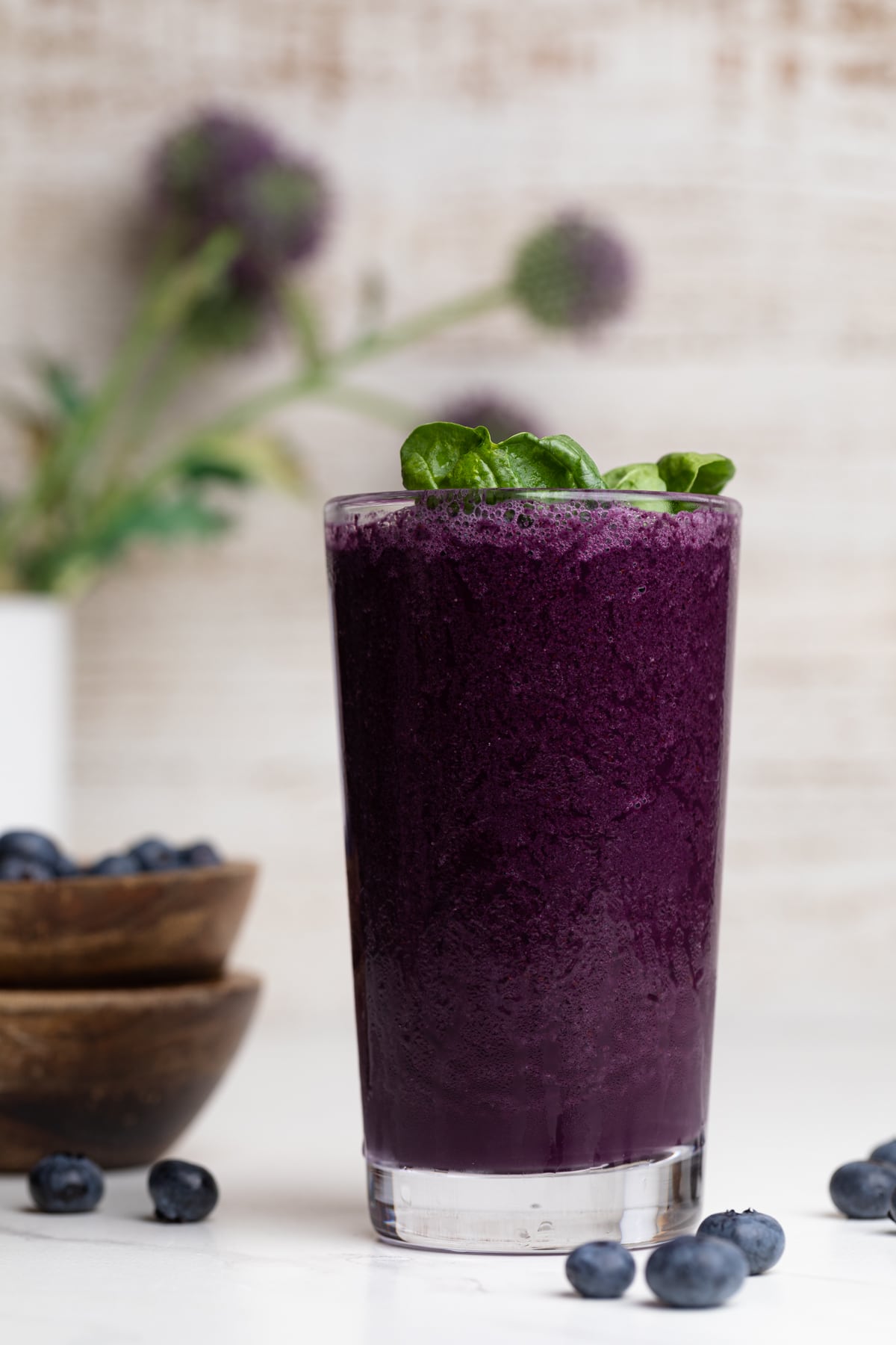 Dark-purple Spinach Blueberry Smoothie in a tall glass