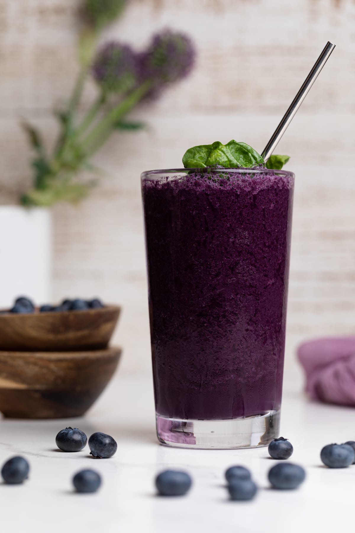 Dark-purple Spinach Blueberry Smoothie with a metal spoon in a tall glass