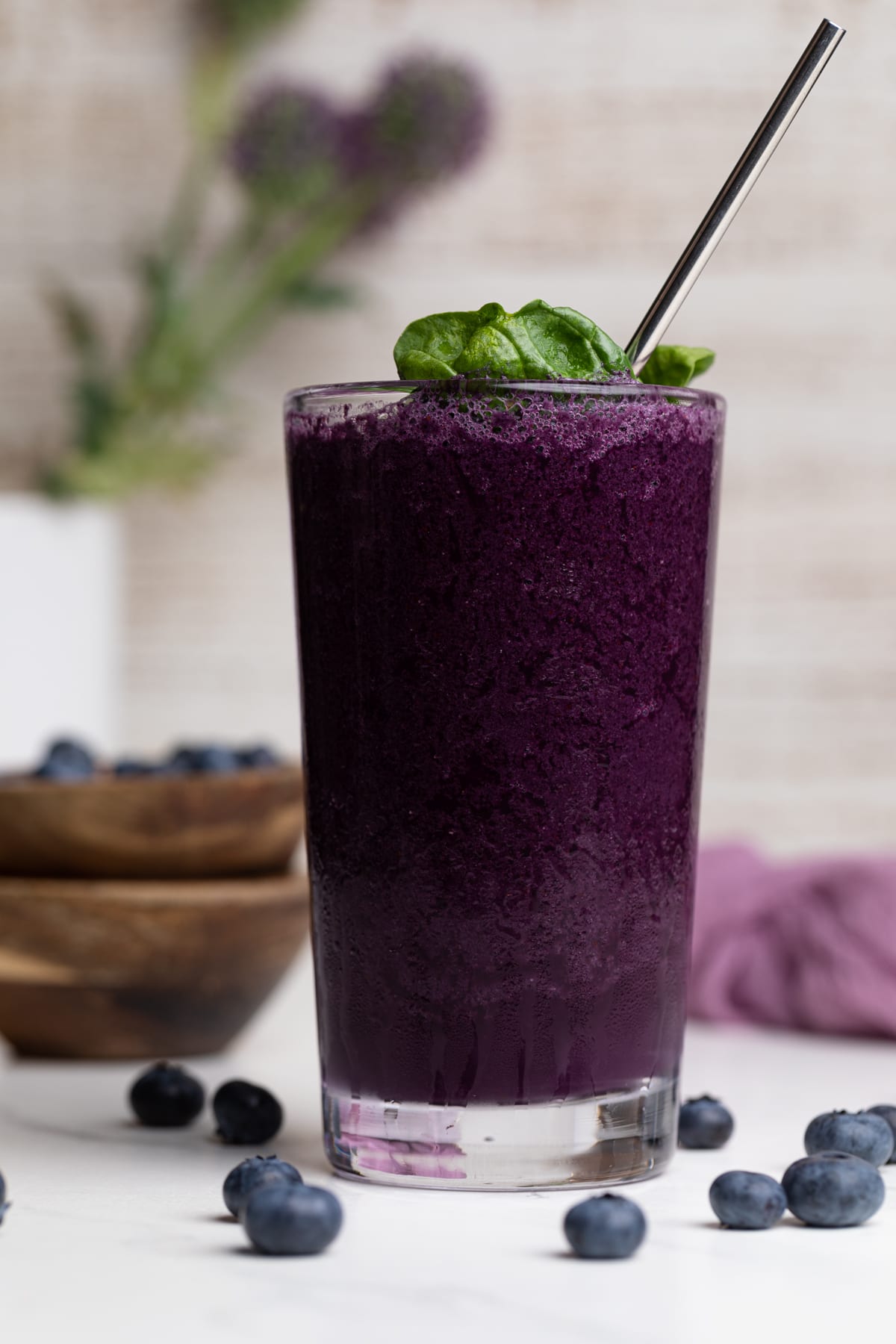 Spinach Blueberry Smoothie in a tall glass with a metal spoon