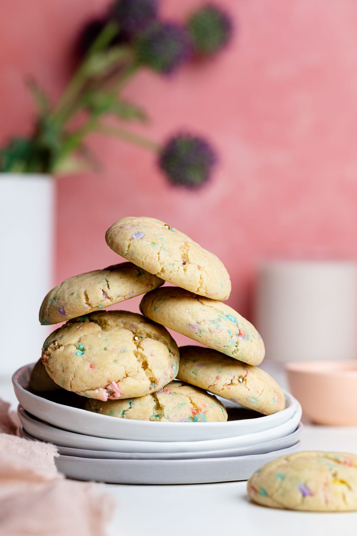 Pile of Thick and Chewy Funfetti Cookies on four small, stacked plates