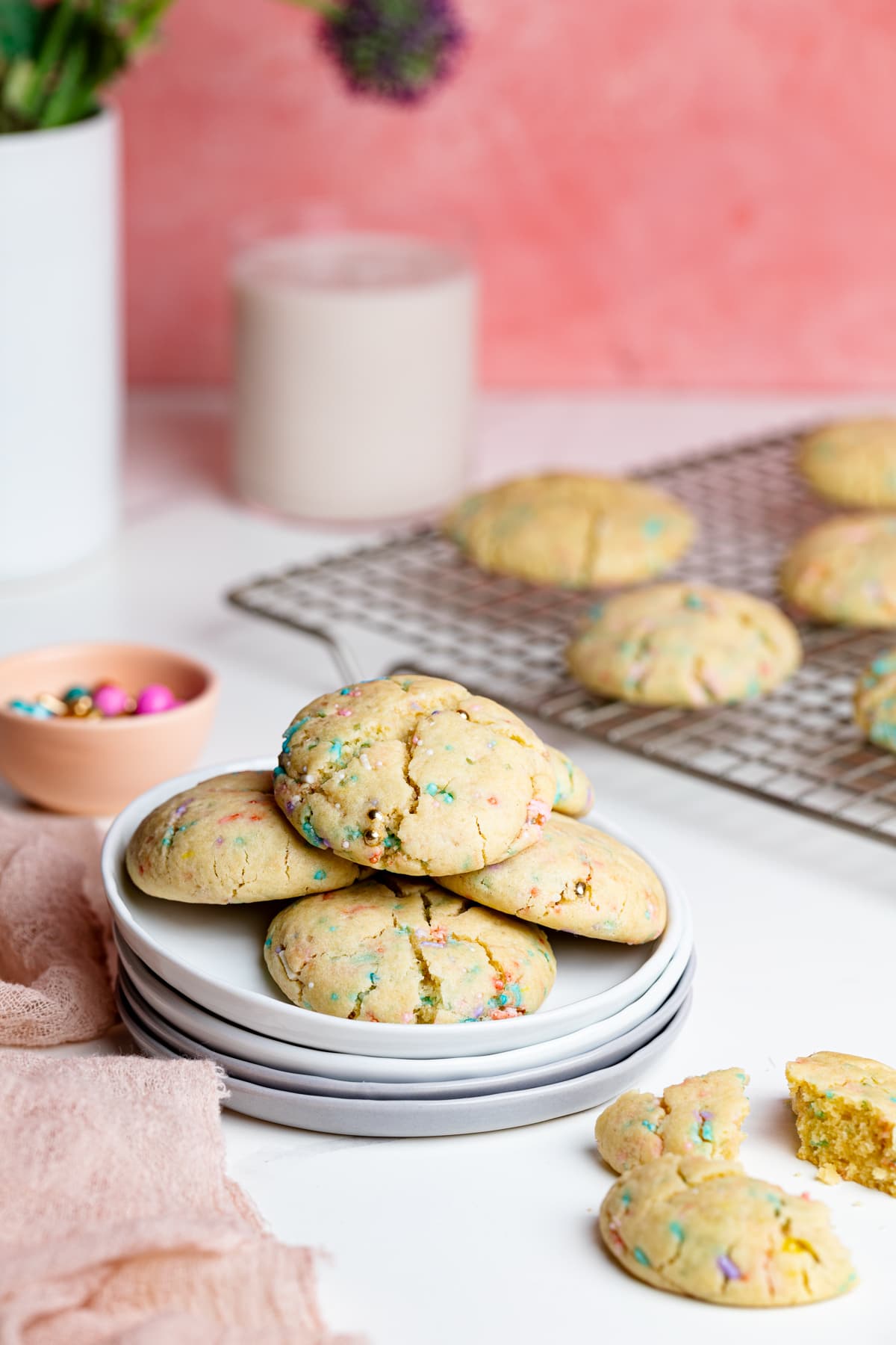 Thick and Chewy Funfetti Cookies on a wire rack and small plates