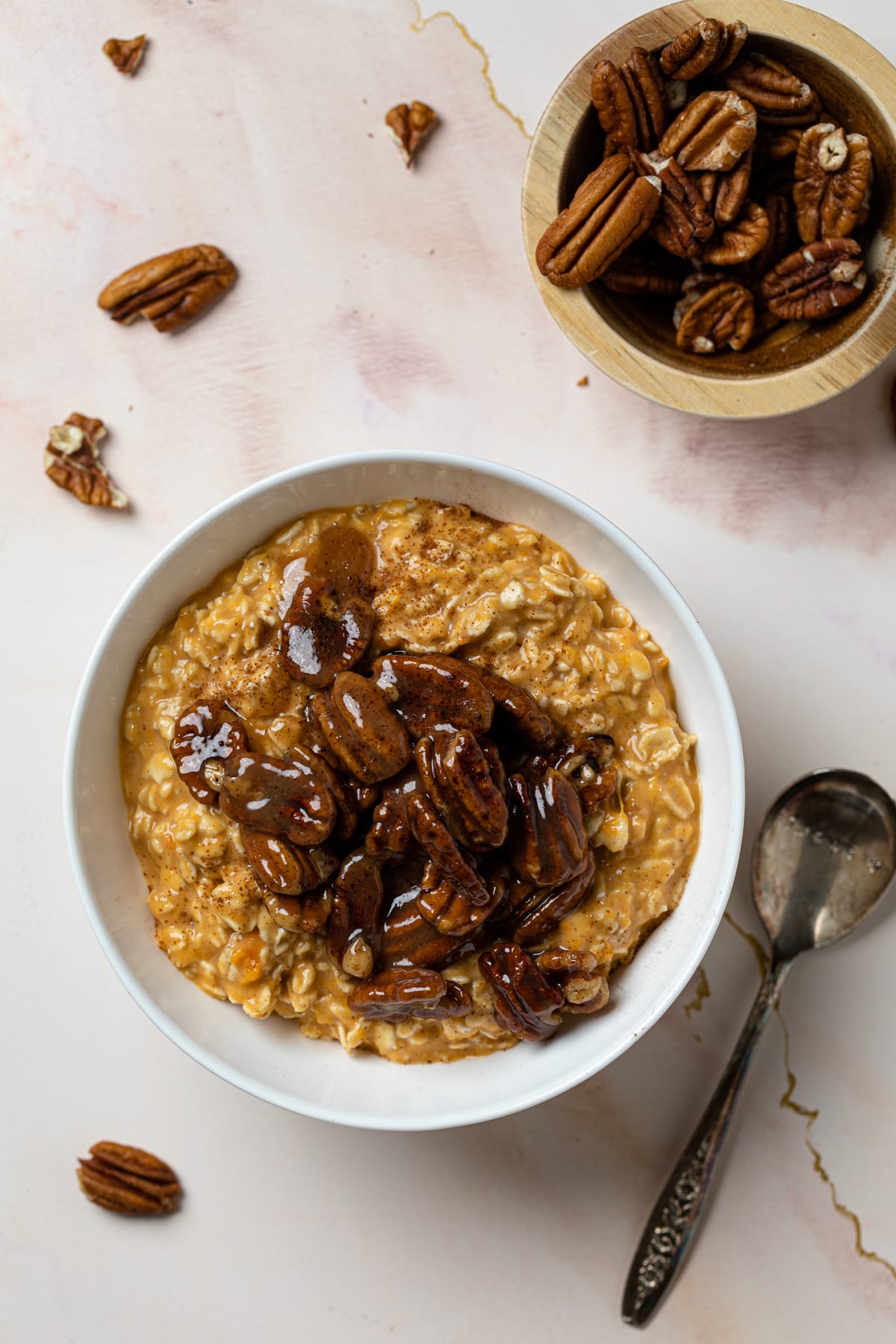 Bowl of Sweet Potato Pie Overnight Oats on a marble table.